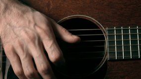 Guitar player's hand touching strings. Music performance. 4K close up dolly video