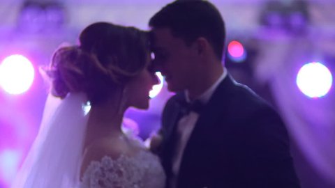 Newlywed couple hugging and dancing on their wedding day