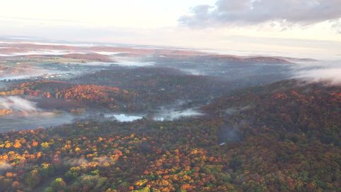 Hudson Valley Fall AERIAL. Sweeping fall aerial view, foggy morning in  New England. Near Berkshires, Catskills, tiny houses in early morning light. 4k 