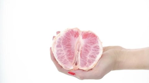 imitation sex. masturbation concept. woman fondles grapefruit. vagina