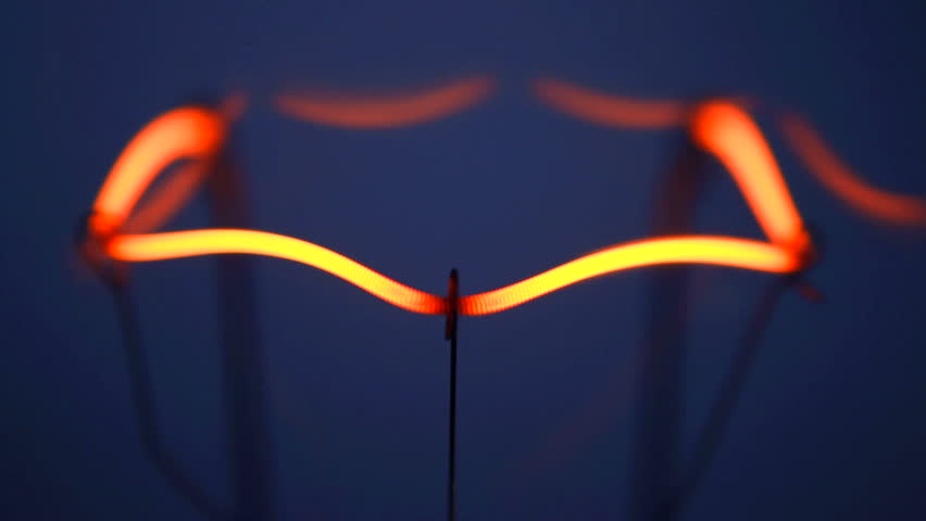 Close up of light bulb filament lighting up