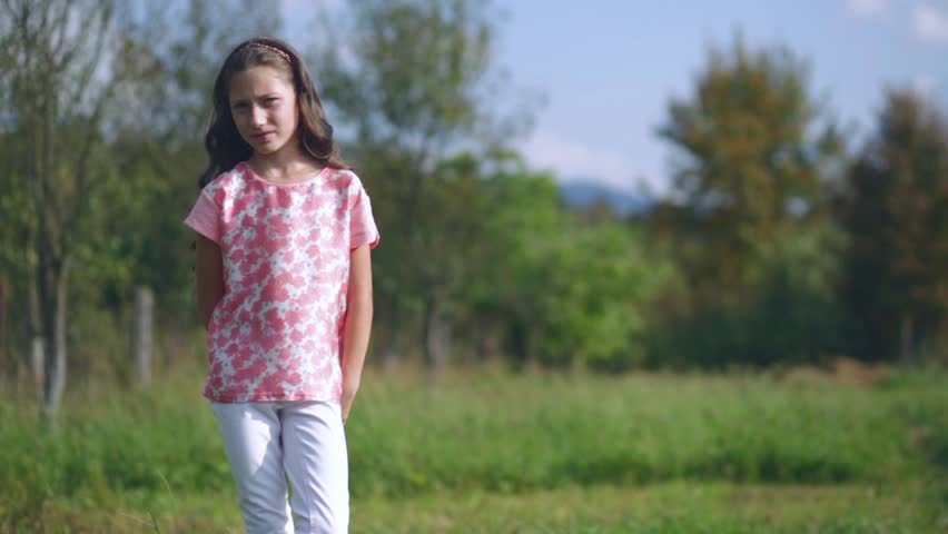 beautiful little girl waving hand on nature