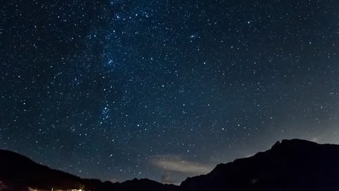 stars and moon in mountain night sky. Moonrise timelapse in 4K. Italy alps