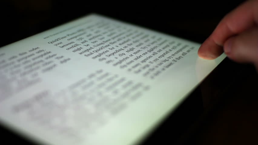 Close-up of a finger turning the pages of a digital ebook reader.  Extreme