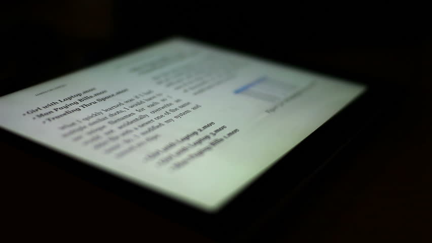 Close-up of a finger turning the pages of a digital ebook reader.  Extreme