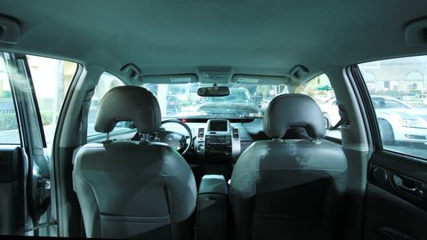 Time Lapse Shot Inside the Back of Moving Car with Male Driving and Female Sitting Passenger