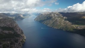 Video from Preikestolen mountain in Norway shot by a drone moving over the lake