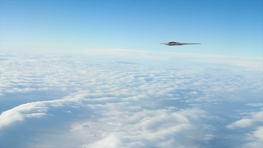 Two B-2 Bombers banking and flying towards the camera.