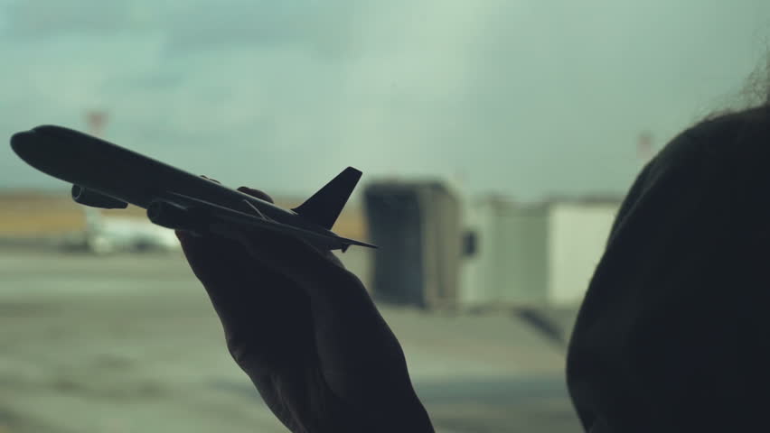 Playing with Toy Airplane in airport terminal