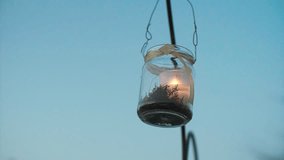 Glass Jar Candle Hanging on Arcch Slow Motion.