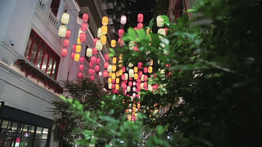 Many traditional chinese colorful paper lanterns hanging on the street. City view at night. Holiday decoration in Hong Kong, China.