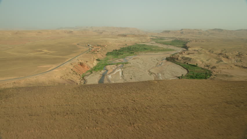 View of dry riverbed, road and fields in north Morocco, Africa (January, 2016-North Morocco, Africa)