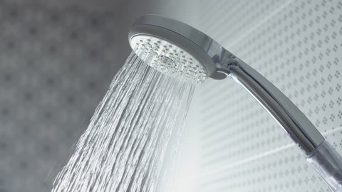 Water drops in the shower head. Slow motion stock footage