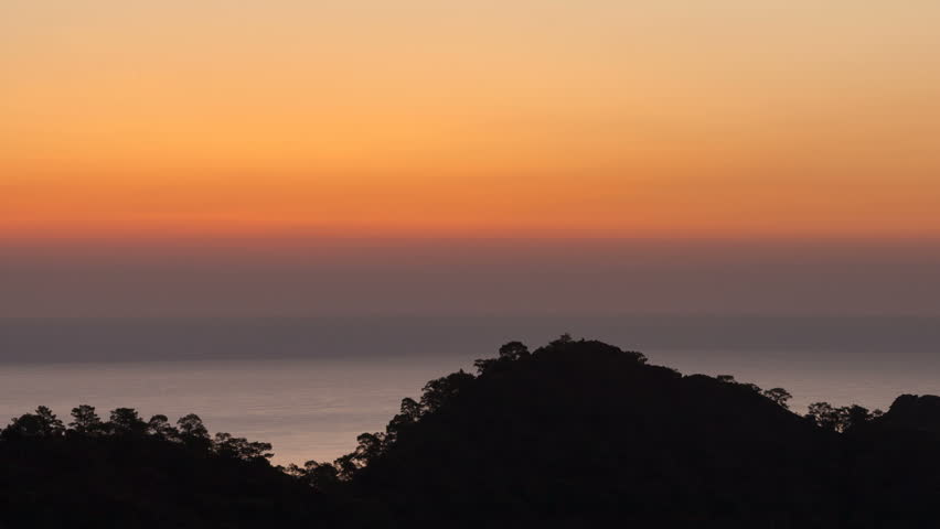 scenic sunrise background sun rising. timelapse of sun rising behing sea and mountains