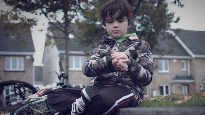 4k Sport Outdoor Child with Bicycle Checking his Smartwatch