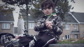 4k Sport Outdoor Child with Bicycle Checking his Smartwatch