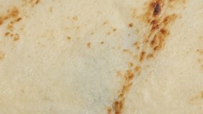 Texture of pancake after being fried slow tilt close-up 4K 2160p 30fps UltraHD footage - Confection surface ready to be filled and rolled for tasty dessert 3840X2160 UHD tilting video