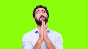 young crazy man praying on chroma background