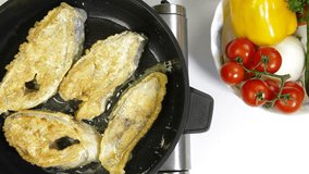 Fried Fish In Frying Pan. Shoot from above, closeup
