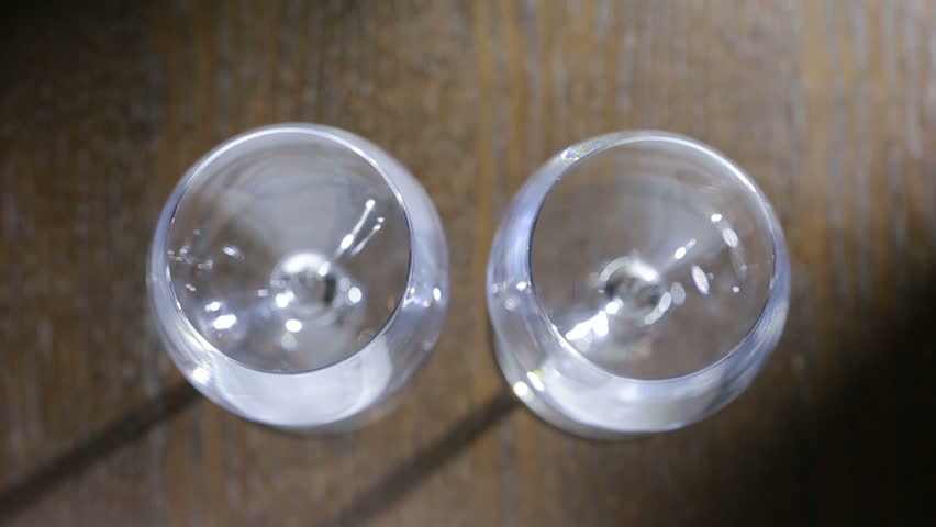 to pour two glasses of red wine. top view. Male and female hands