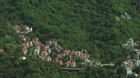 Aerial view of rural house in the green mountain of Taipei city from above of the building 101, South Area High Angle of Taiwan Capital -Dan
