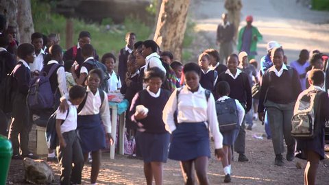 African school children walking to school in morning light.Circa Cape Town,October 2016