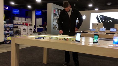Coquitlam, BC, Canada - October 21, 2016 : Man trying new iwatch inside store with 4k resolution