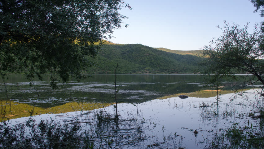 Evening comes. Lake at the evening. Time lapse slider.