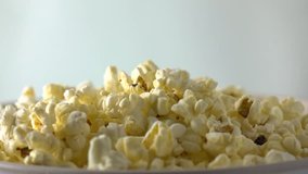 Pouring popcorn into box. Cinema or fast food concepts. Super slow motion dolly video