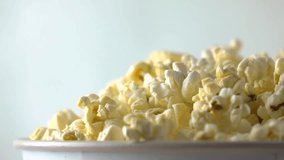 Pouring popcorn into paper box. Cinema or fast food concepts. Super slow motion dolly video