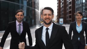 Slow motion. Three confident positive emotional happy exulting of winning Business people rejoice and jump high in air with happiness. Modern glass Business centre building district bg. Phantom flex - Powered by Shutterstock - Get 15% off with code: PIKWIZARD15