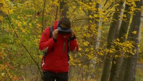 Man in 360Vr Helmet is Walking Around and Watching Video 360 Degrees, Turning His Head. Young Man in Park Takes the Headset Off and Looking at the Autumn Landscape, Watching Video in Virtual Reality