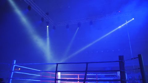 Boxing ring in lights of projectors before fight night