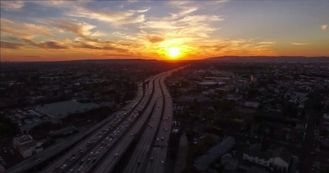 4K UHD static aerial timelapse wild view of heavy traffic on 10 freeway and sunset in Downtown, Los Angeles, California, USA