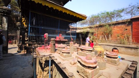BHAKTAPUR, NEPAL - APRIL 9, 2016: Temple with Lingams. The Lingam is an abstract or aniconic representation of Shiva and seen as a symbol of the energy and potential of Shiva himself