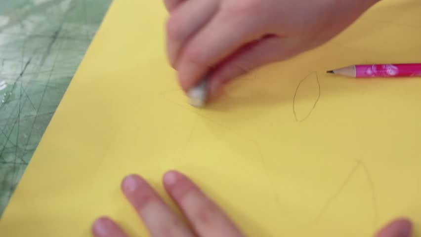 The girl draws a picture paints in classroom