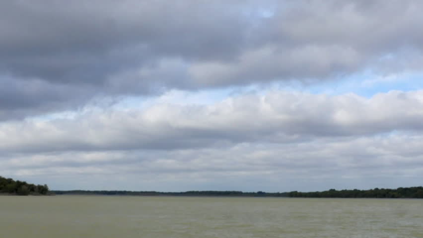 Time lapse Clouds over large lake in HD