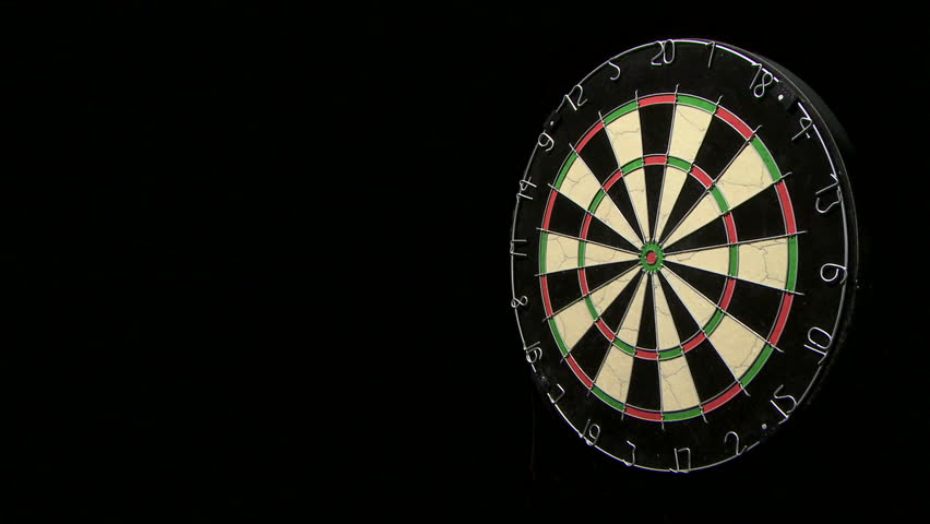 Wide shot of a single dart hitting the bull's eye on a dart board