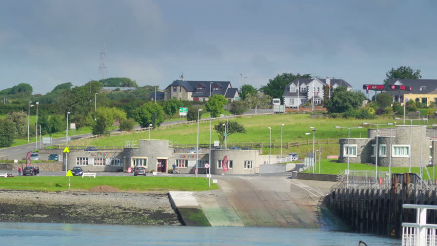 A landscape view of the Killimer village in Ireland it has bunk houses and a river