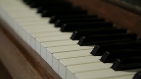 Piano keyboard slow panning over black and white keys