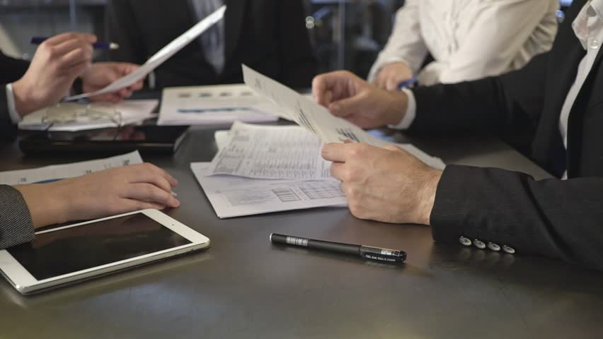 Business people exchanging documents, closeup shot Royalty-Free Stock Footage #20878894