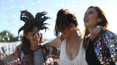 Female friends dancing at summer festival