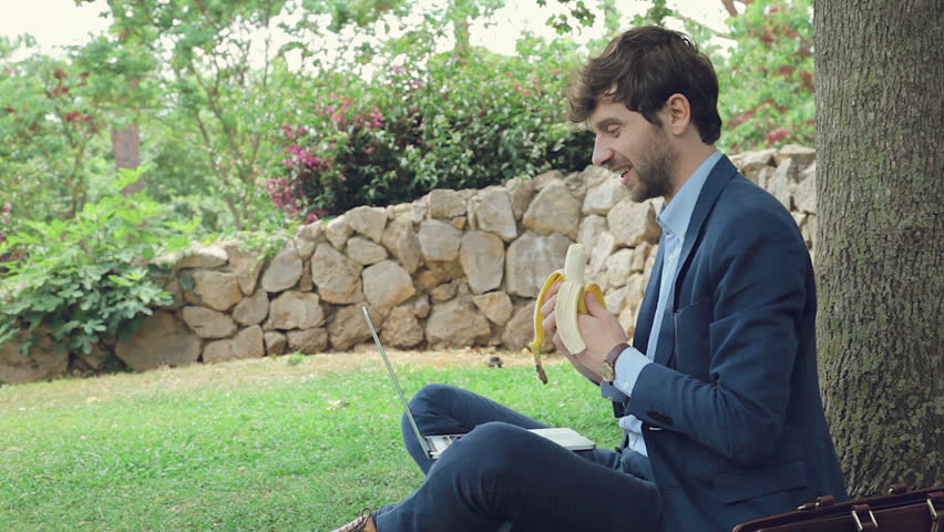 Business man in spring talking on the phone while working with tablet
