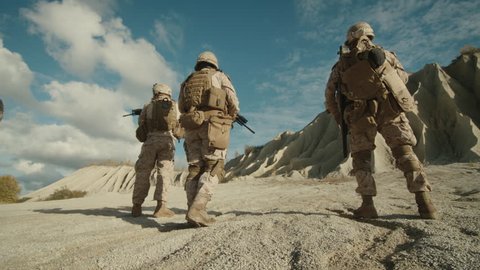 Follow Shot of Squad of Soldiers Running Forward During Military Operation in the Desert.  Shot on RED EPIC Cinema Camera in 4K (UHD).