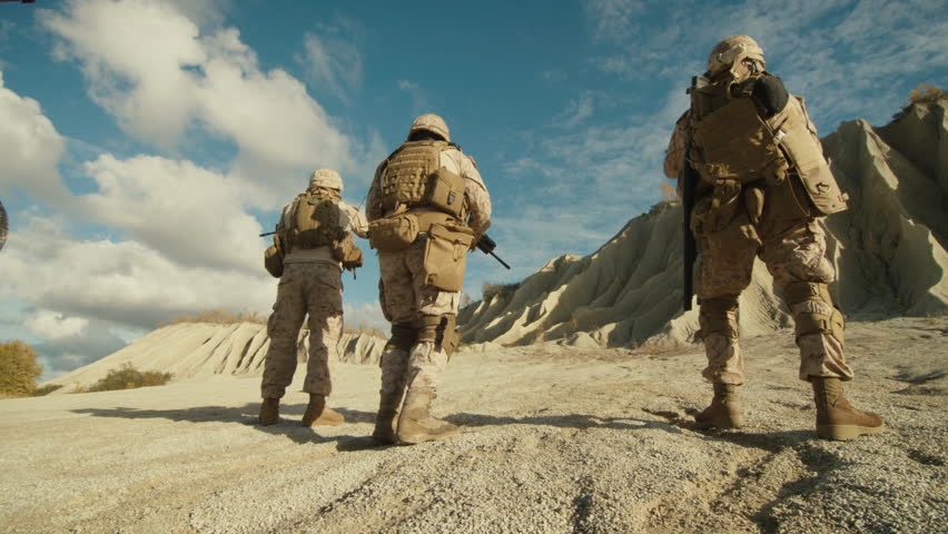 Follow Shot of Squad of Soldiers Running Forward During Military Operation in the Desert. Slow motion.Shot on RED EPIC Cinema Camera in 4K (UHD).