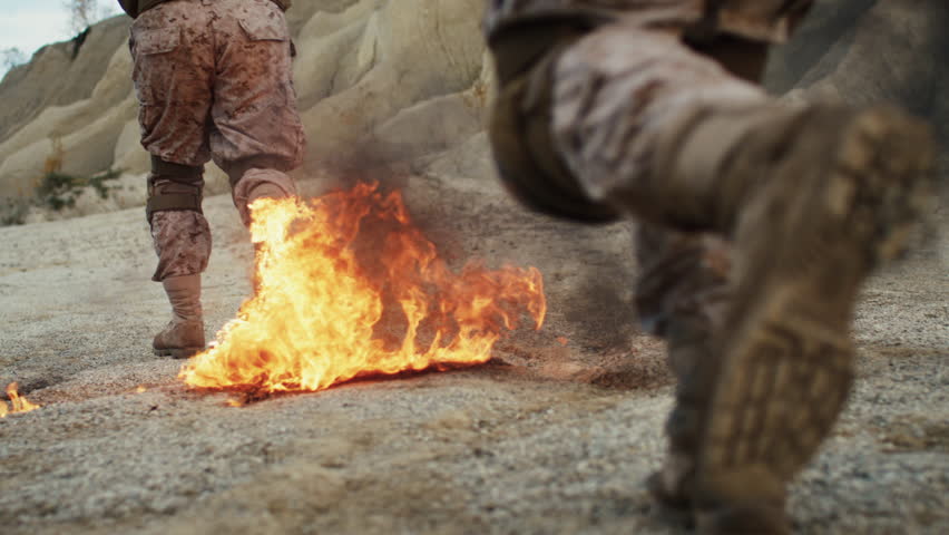 Close-up Shot of Soldiers Running on Burning Ground in the Desert. Slow Motion. Shot on RED EPIC Cinema Camera in 4K (UHD).