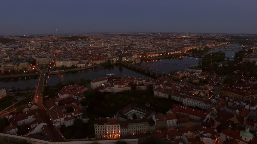 Aerial - Evening time in Prague. City panorama with view to the Vltava river and red rooftop houses. Czech Republic, Europe