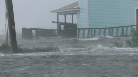 Cocoa Beach, FL/US - October 8, 2016 [4K Hurricane Matthew storm surge flooding and waves wrapping around large house during peak hurricane force winds.]