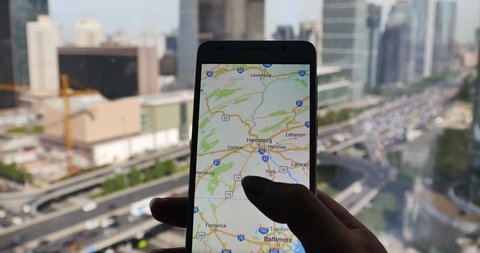 4k,human browse map on smartphone with business building & urban traffic background. gh2_11601_4k