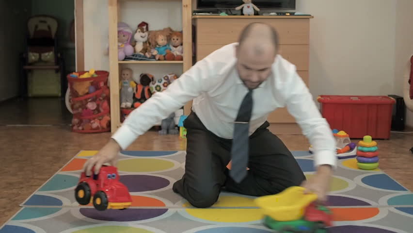 Adult Male Businessman Playing Toy Cars